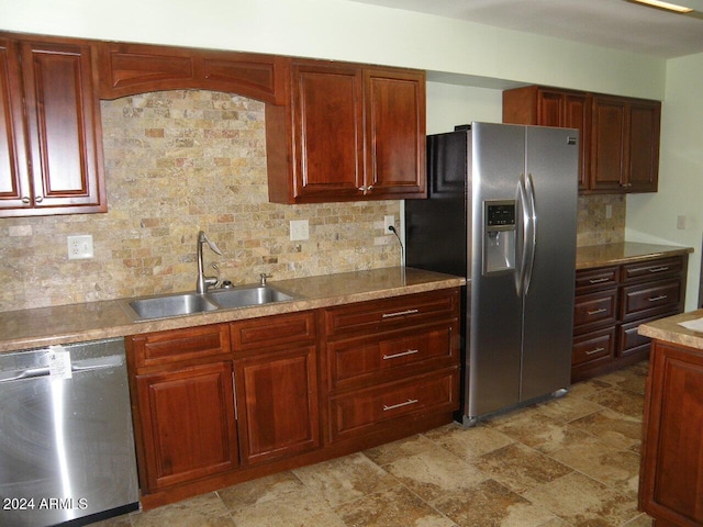 kitchen featuring decorative backsplash, sink, and appliances with stainless steel finishes