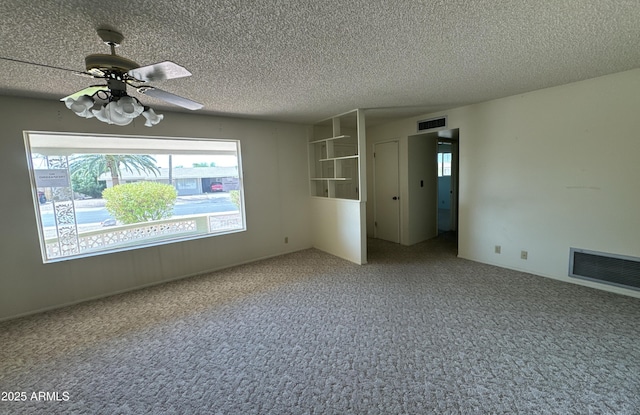 interior space featuring ceiling fan, visible vents, and a textured ceiling