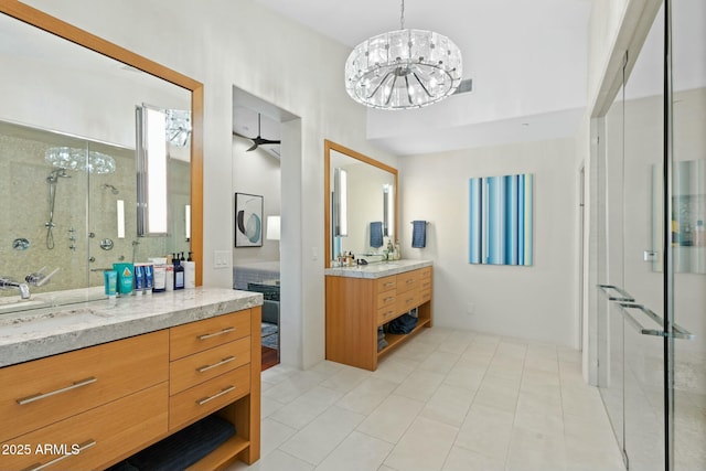 bathroom featuring vanity, an enclosed shower, tile patterned floors, and a chandelier