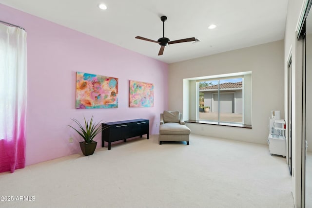 sitting room with light carpet and ceiling fan