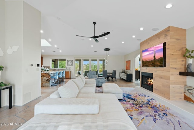 living room featuring lofted ceiling and ceiling fan