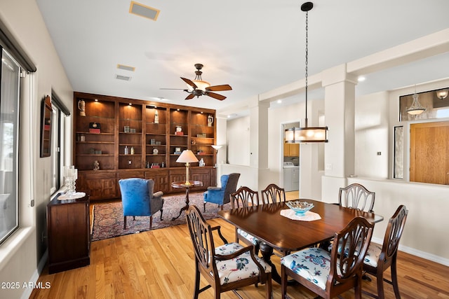 dining area with ceiling fan, light hardwood / wood-style floors, and ornate columns