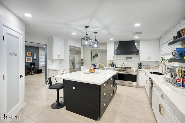 5441 E Wethersfield Rd, Scottsdale, AZ 85254 - kitchen featuring appliances with stainless steel finishes, a sink, premium range hood, white cabinetry, and dark cabinets
