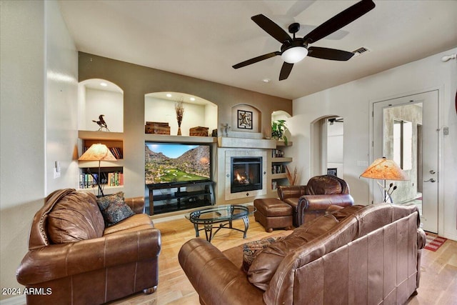 living room with light hardwood / wood-style floors and ceiling fan