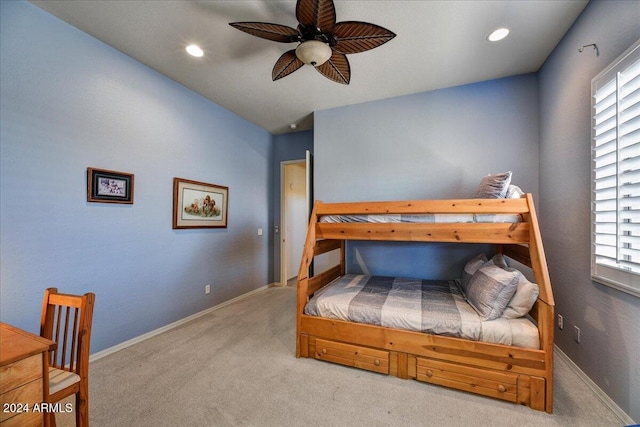 carpeted bedroom with multiple windows, lofted ceiling, and ceiling fan