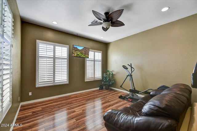 living area featuring ceiling fan and wood-type flooring