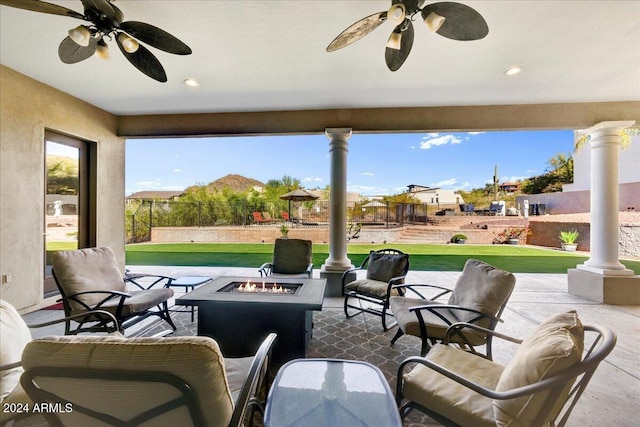 view of patio / terrace featuring a fire pit and ceiling fan