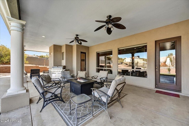 view of patio / terrace with area for grilling, an outdoor fire pit, and ceiling fan