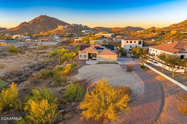 aerial view at dusk featuring a mountain view