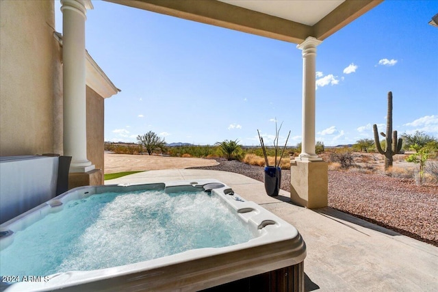 view of swimming pool with a hot tub