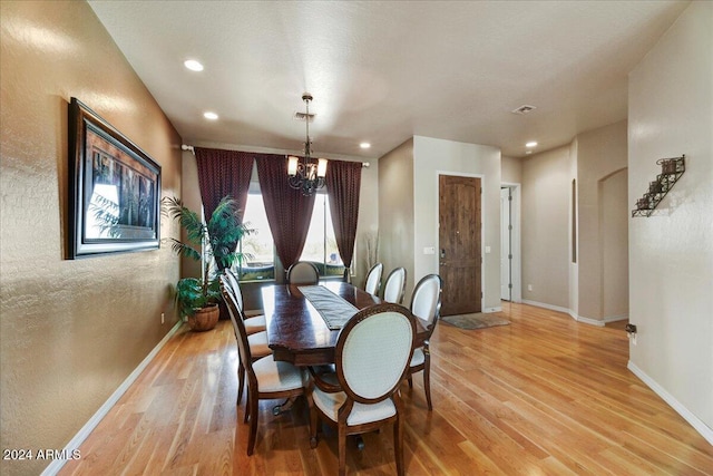 dining area featuring a chandelier and light hardwood / wood-style floors