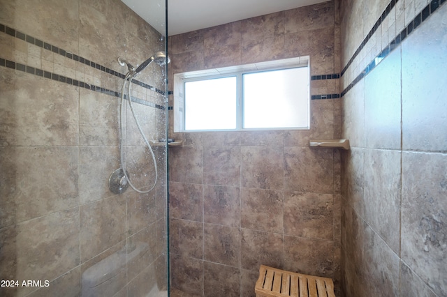 bathroom with a tile shower