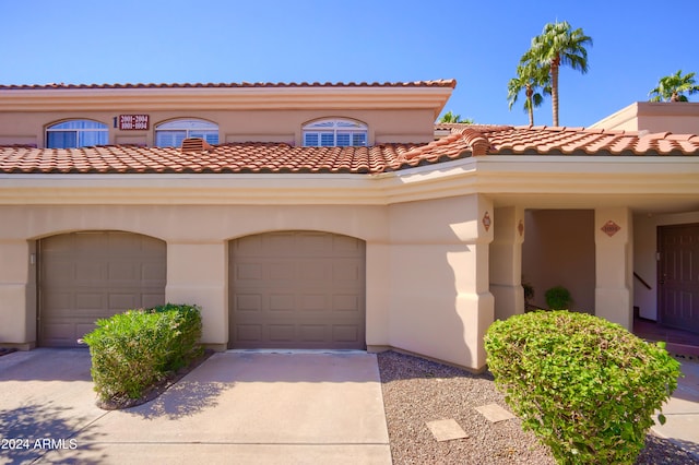 mediterranean / spanish-style home featuring a garage