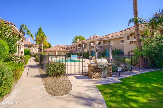 view of property's community featuring a swimming pool and a yard