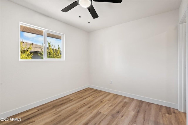 spare room with ceiling fan and light wood-type flooring