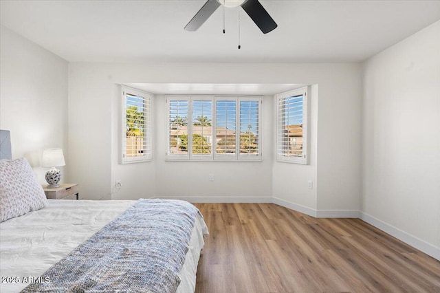 bedroom with hardwood / wood-style floors and ceiling fan