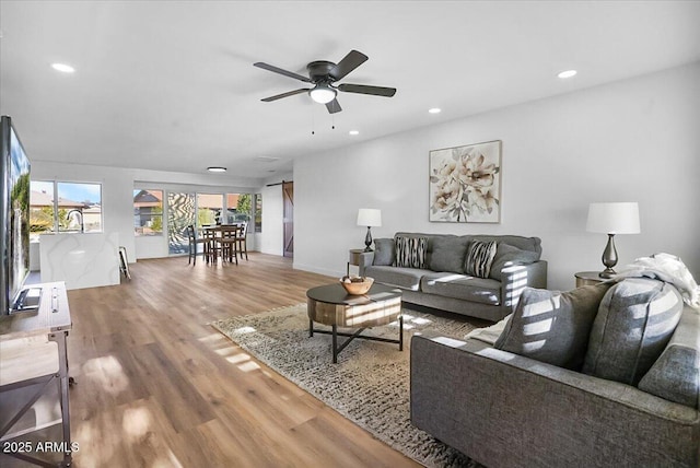 living room featuring ceiling fan and wood-type flooring