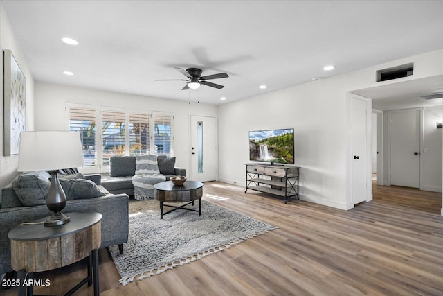 living room with ceiling fan and hardwood / wood-style floors