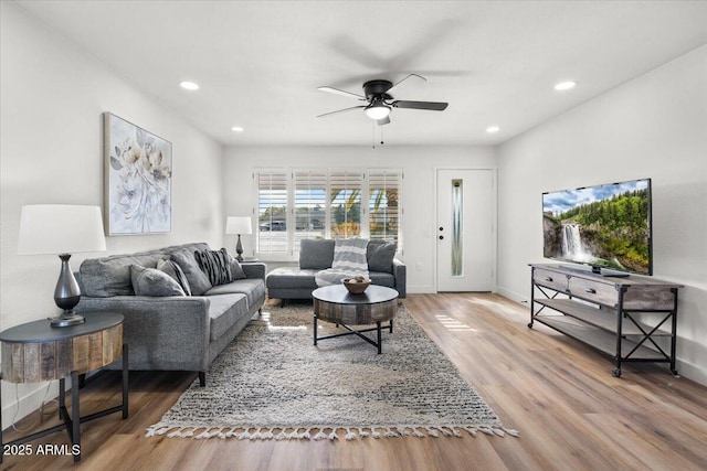 living room featuring hardwood / wood-style flooring and ceiling fan