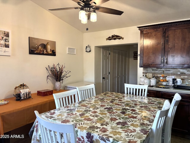 dining room featuring ceiling fan and lofted ceiling