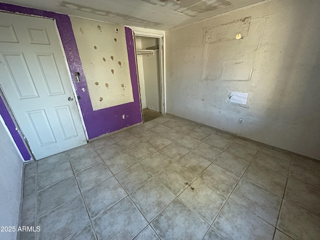 unfurnished bedroom with tile patterned flooring and a closet