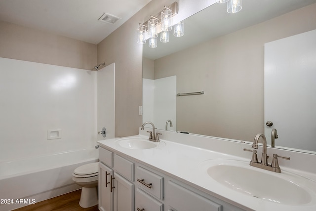 full bathroom featuring vanity, toilet, wood-type flooring, and shower / tub combination