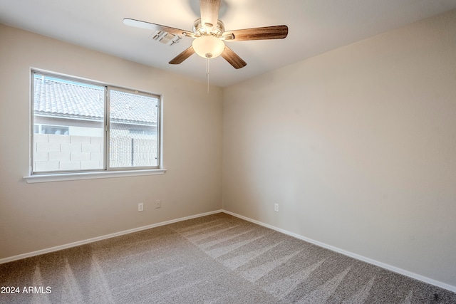 spare room featuring carpet floors and ceiling fan