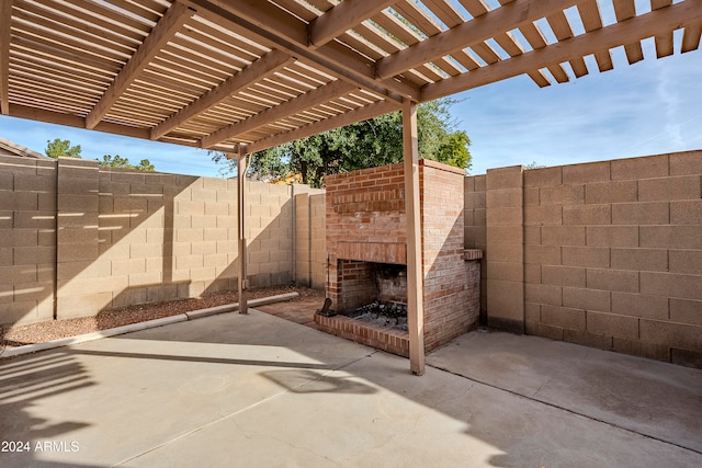 view of patio / terrace with a pergola and an outdoor brick fireplace