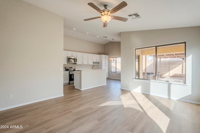 unfurnished living room with ceiling fan with notable chandelier, light hardwood / wood-style flooring, lofted ceiling, and sink