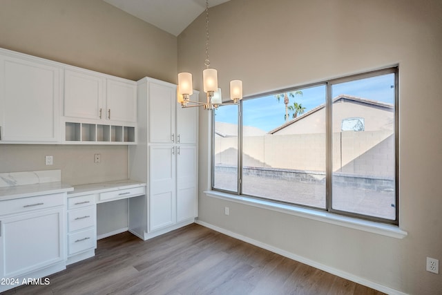 kitchen featuring plenty of natural light, light wood-type flooring, and hanging light fixtures