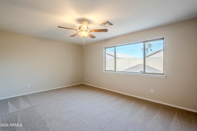 carpeted spare room with ceiling fan