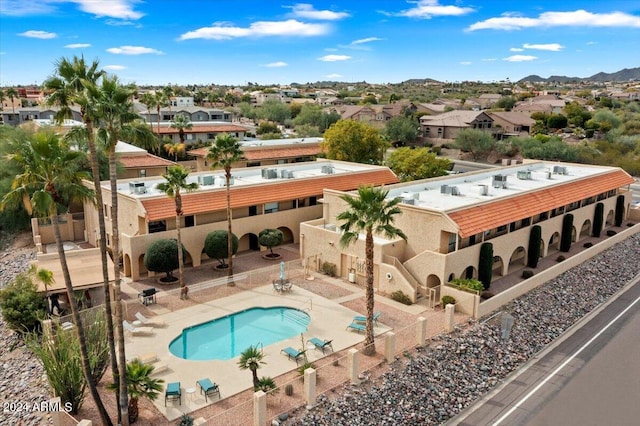 view of swimming pool with a patio and a mountain view