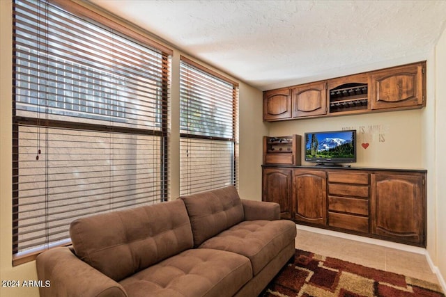 tiled living room with a textured ceiling