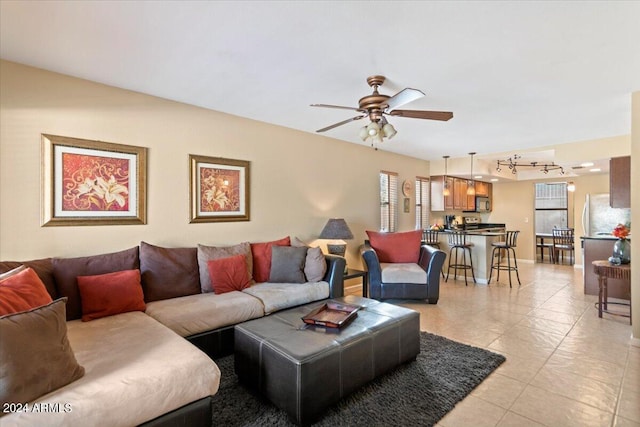 tiled living room featuring ceiling fan