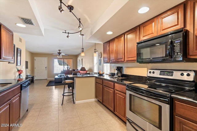 kitchen featuring light tile patterned flooring, rail lighting, ceiling fan, stainless steel appliances, and hanging light fixtures