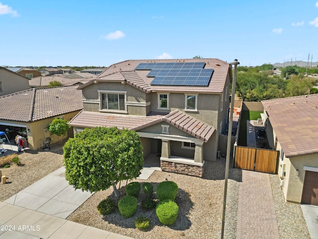 view of front of home featuring solar panels