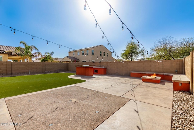 view of patio / terrace with a fire pit and a fenced backyard