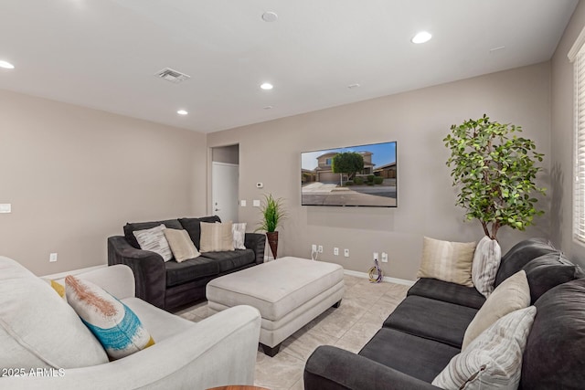 living room with recessed lighting, visible vents, and baseboards