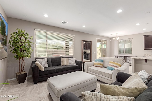 living area with baseboards, visible vents, and recessed lighting