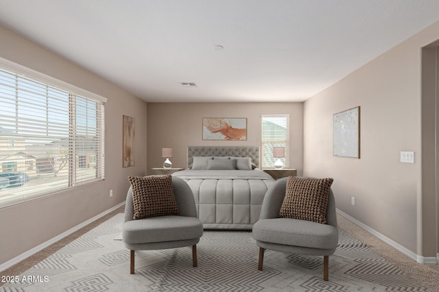 bedroom featuring visible vents, light colored carpet, and baseboards