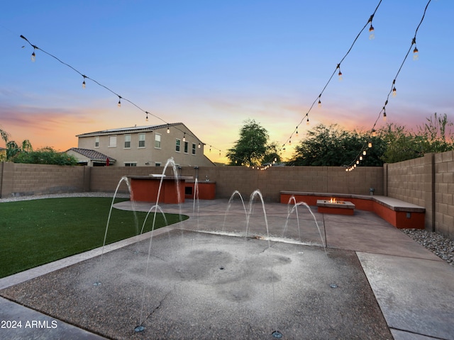 pool at dusk with a patio