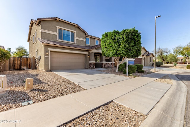 view of front of house with concrete driveway, a garage, stucco siding, and fence