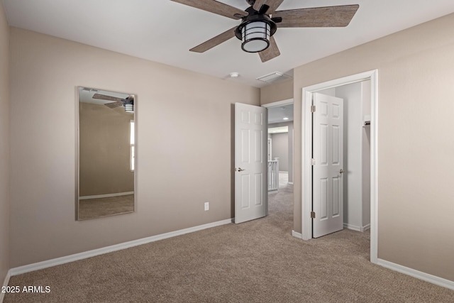 unfurnished bedroom featuring baseboards, visible vents, a ceiling fan, and carpet flooring