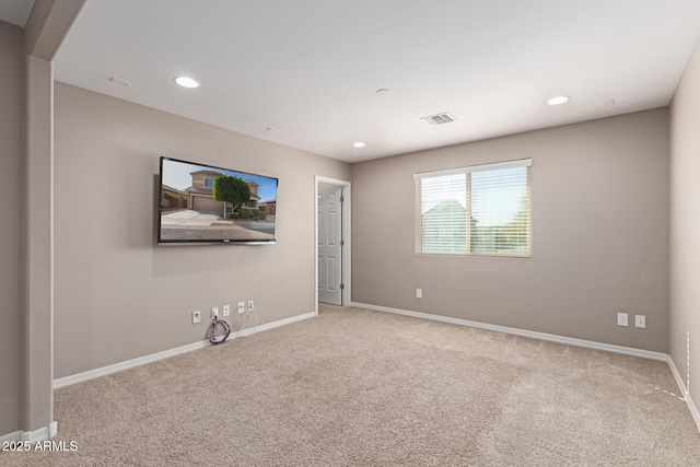 unfurnished room featuring baseboards, visible vents, carpet floors, and recessed lighting