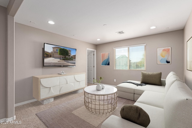 carpeted living area with visible vents, recessed lighting, and baseboards