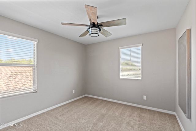 spare room with light carpet and ceiling fan