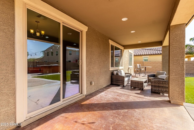 view of patio featuring fence, outdoor dining space, and visible vents