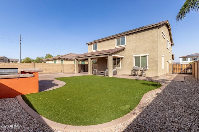 back of property featuring a patio, stucco siding, and a fenced backyard