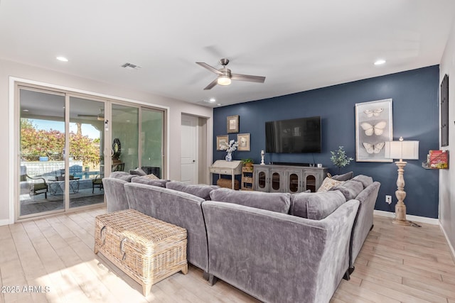 living room featuring light hardwood / wood-style floors and ceiling fan