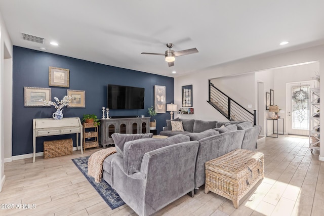 living room featuring ceiling fan and light hardwood / wood-style floors